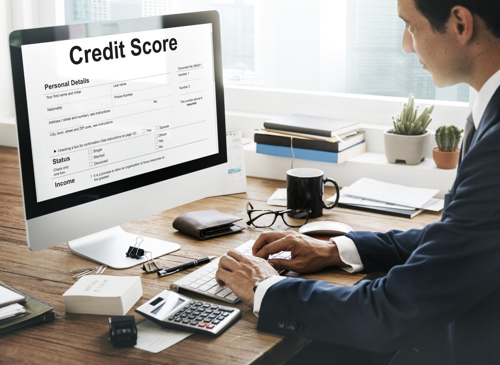 Business owner analyzing financial documents to protect business credit score during debt restructuring.